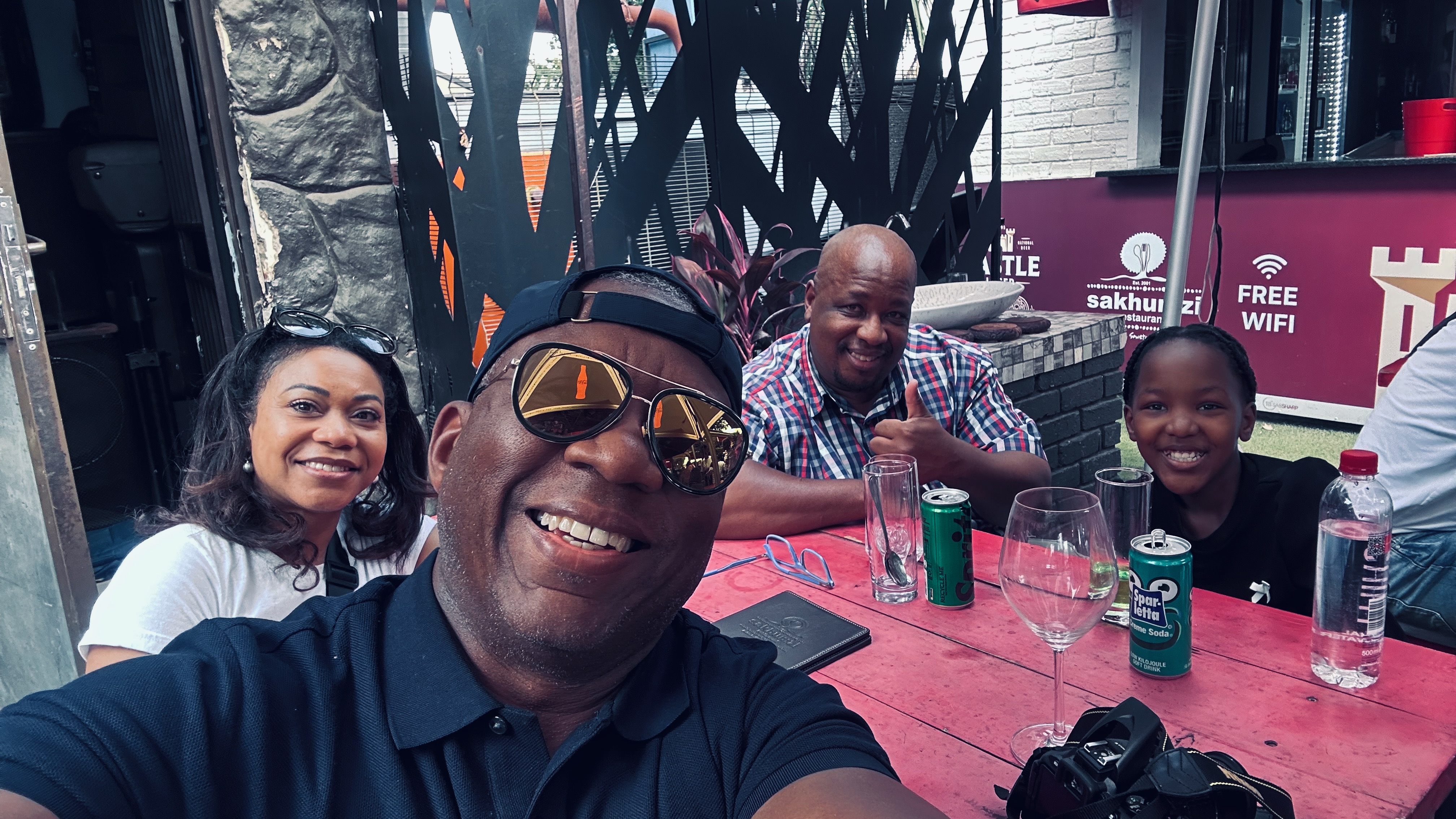 William and companions sharing lunch at Sakhumzi in Soweto