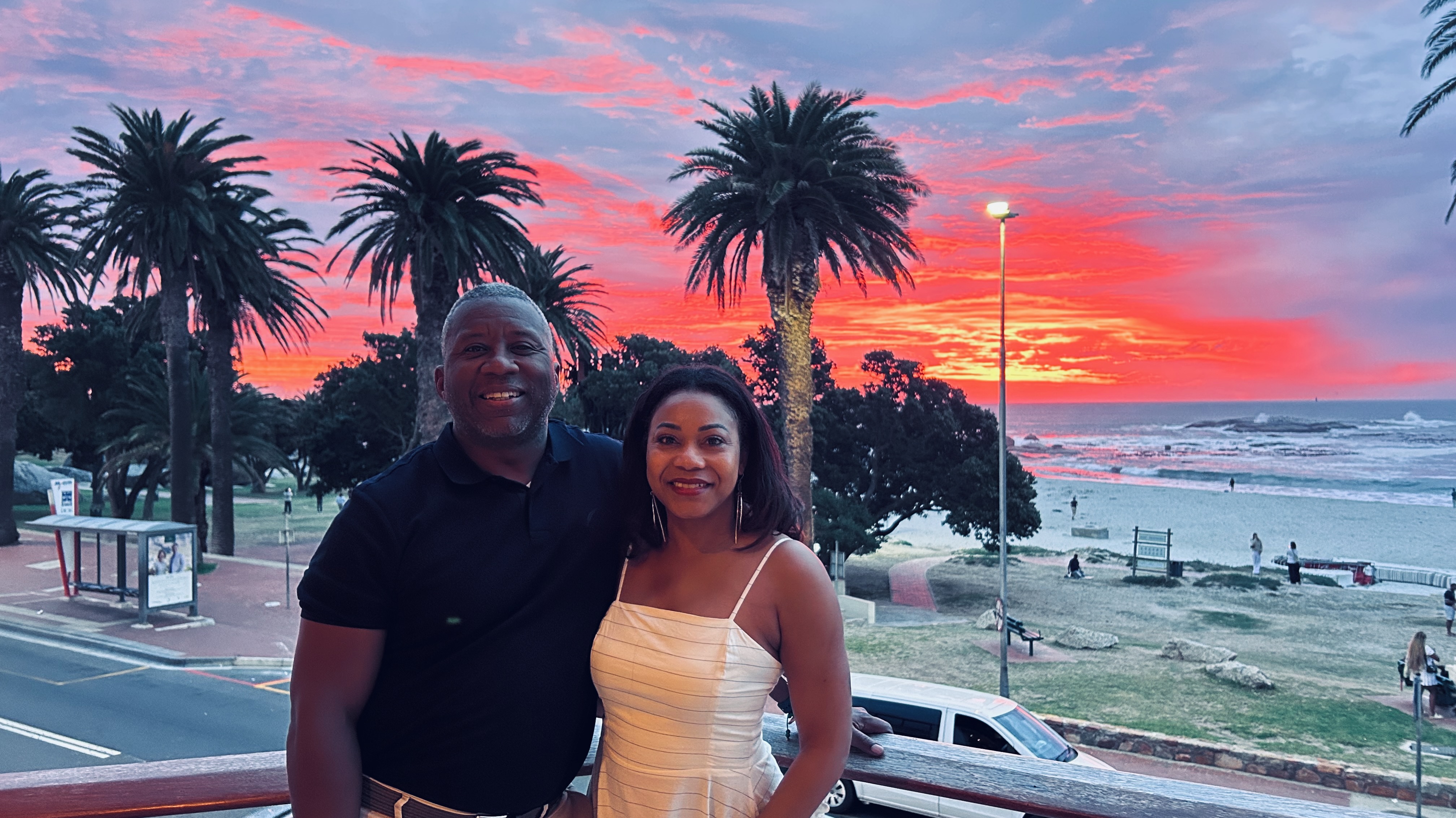 William and a companion against a vivid South African coastal sunset