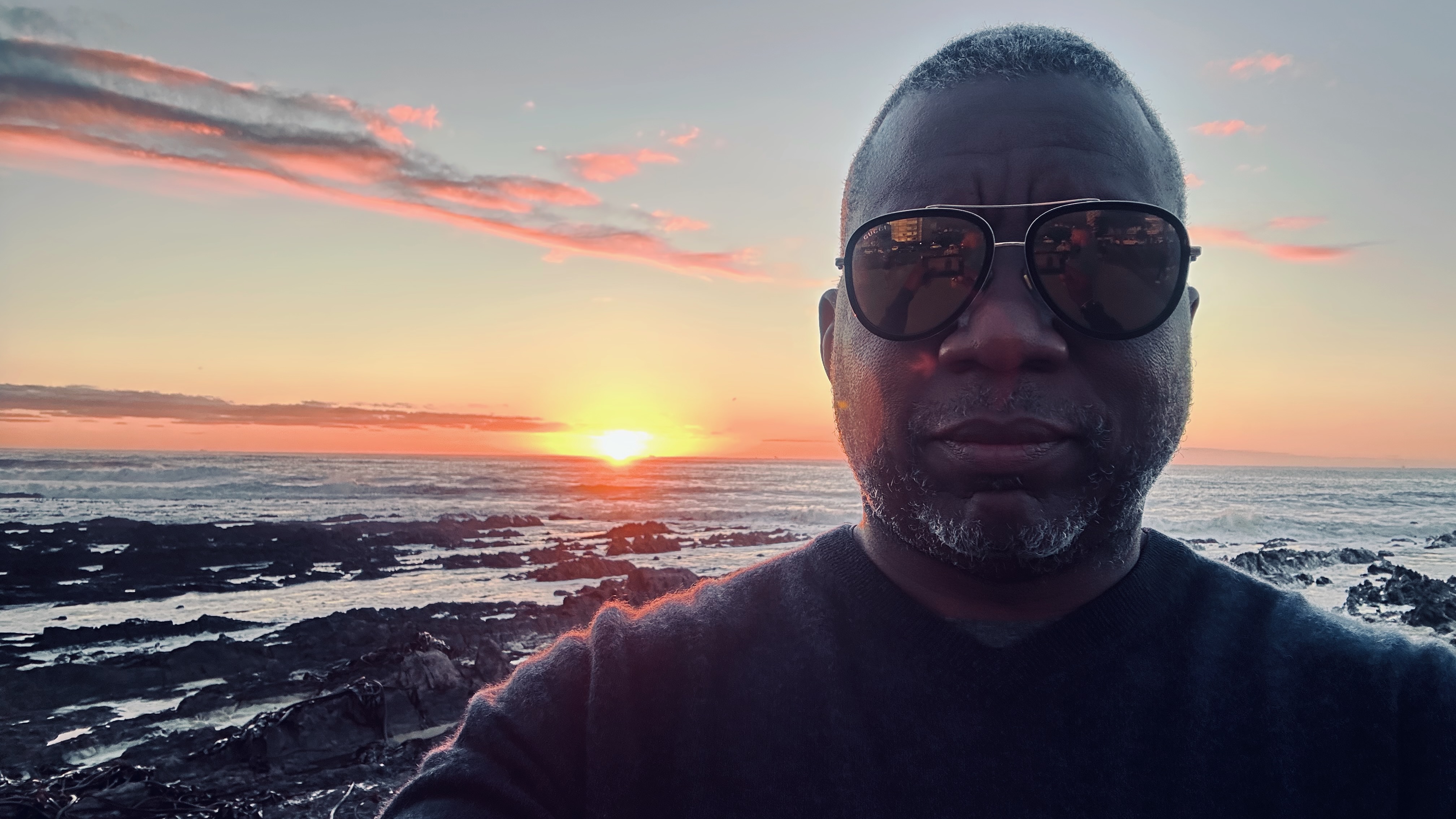 William beside the ocean at sunset in South Africa