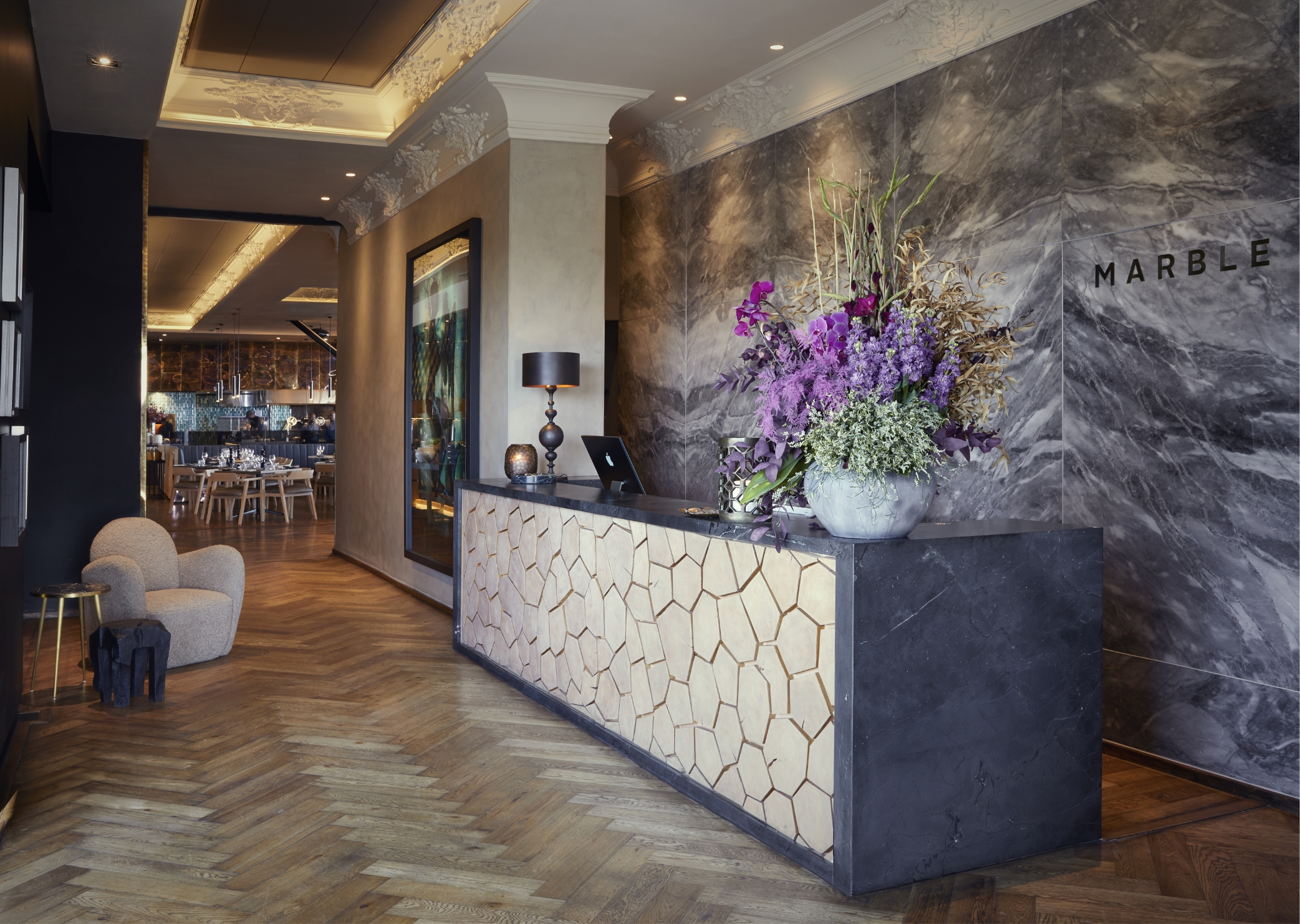The marble-clad entrance and dining setting at Marble Johannesburg